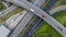 Aerial top view of highway junction interchange road. Drone view of the elevated road, traffic junctions, and green garden.