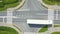 Aerial top view of highway junction interchange road. Drone view of the elevated road, traffic junctions, and green garden.