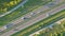 Aerial top view of highway road. Drone view of the elevated road, traffic junctions, and green garden. Transport trucks and cars