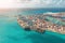 Aerial top view huge cargo ship moored at the pier at the port, loading goods