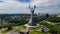 Aerial top view of Kiev Motherland statue monument on hills from above and cityscape, Kyiv, Ukraine