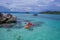 Aerial top view of man kayaking in crystal clear lagoon sea water near Koh Kra island in Thailand