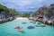 Aerial top view of man kayaking in crystal clear lagoon sea water near Koh Kra island in Thailand