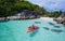 Aerial top view of man kayaking in crystal clear lagoon sea water near Koh Kra island in Thailand