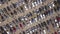 Aerial top view of many cars parked and people customers walking on car market or parking lot.