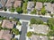 Aerial top view of middle class subdivision neighborhood with residential villas next to each other.