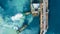 Aerial top view oil tanker ship at terminal industrial port tugboat drag crude oil tanker ship park to port for transfer crude oil