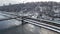 Aerial top view of pedestrian Park bridge in winter and Dnieper river from above, snow Kyiv cityscape, city of Kiev skyline