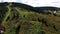 Aerial top view of racers riding a quad motorbike in the countryside through the muddy trail on green meadow. Stock