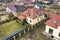 Aerial top view of residential area with new houses with roof solar photo voltaic panels, wind turbine mill and stand-alone