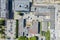 Aerial top view of roofs of industrial warehouses and parked cars at city industrial area