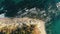 Aerial top view of sea waves hitting rocks on the beach