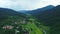 Aerial top view of sky road over top of mountain with farmland green jungle forest in sunny summer day at Pua district Nan provinc