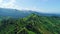 Aerial top view of sky road over top of mountain with farmland green jungle forest in sunny summer day at Pua district Nan provinc