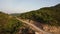 Aerial top view of sky road on top of mountain with green tropical jungle.