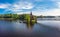 Aerial top view to wooden Church of St. Apostle Andrew First-Called on Vuoksa River with bridge. Temple on small island