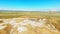 Aerial top view tourist explore mud volcanoes in Chachuna nature reserve with green landscape background in sunny day