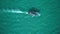 Aerial top view of traditional wooden longtail boat in open turquoise sea during sunny summer day