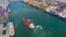 Aerial top view Tugboat drag Oil red ship tanker to dock