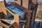 Aerial top view of unfinished tall apartment building, annex room under construction, high chimneys and plastic windows on tiled