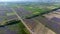 Aerial top view of vast colorful agricultural fields with country road on the middle