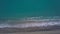 Aerial top view waves break on empty pebble beach sea from bird`s eye view
