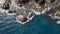 Aerial top view of waves break on rocks in a blue ocean. Sea waves on beautiful beach aerial view drone 4k shot. Bird`s eye view