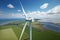 Aerial top view of white windmill with cloud blue sky, wind turbines on field grass, fresh air from windmill farm, with Generative