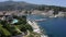 Aerial tracking shot across a Greek fishing harbour entrance during  summer time