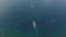 Aerial tracking shot of a motorboat moving fast in the sea on summer day.