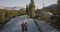 Aerial tracking shot of young romantic couple hugging, hiking together on amazing white rock at Yosemite park forest.