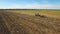 Aerial: Tractor plowing the soil