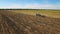 Aerial: Tractor plowing the soil