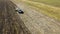 Aerial: Tractor plowing the soil