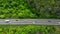 Aerial. Traffic on the intercity highway between the natural parkland. Top view