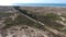 Aerial. Train goes through the Ria Formosa to the beach Barry.