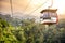 Aerial tramway moving up in tropical jungle mountains