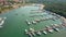 Aerial travelling shot of Mediterranean marina piers and anchored boats and yachts on a sunny summer day