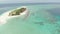 Aerial: tropical atoll view from above, blue lagoon turquoise water coral reef, Wakatobi Marine National Park, Indonesia - concept