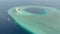 Aerial: tropical atoll view from above, blue lagoon turquoise water coral reef, Wakatobi Marine National Park, Indonesia - concept