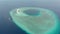 Aerial: tropical atoll view from above, blue lagoon turquoise water coral reef, Wakatobi Marine National Park, Indonesia - concept