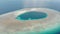 Aerial: tropical atoll view from above, blue lagoon turquoise water coral reef, Wakatobi Marine National Park, Indonesia - concept
