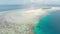 Aerial: tropical atoll view from above, blue lagoon turquoise water coral reef, Wakatobi Marine National Park, Indonesia - concept