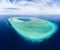 Aerial: tropical atoll view from above, blue lagoon turquoise water coral reef, Wakatobi Marine National Park, Indonesia - concept