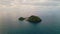 Aerial tropical island washing by atlantic ocean water. Endless marine landscape