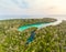 Aerial: tropical paradise pristine coast line rainforest blue lake at Bair Island. Indonesia Moluccas archipelago, Kei Islands,