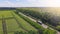 Aerial. Truck driving by the roadway between agricultural fields