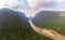 Aerial unique view from drone: Nam Ou river valley at Muang Ngoi Laos, sunset colorful sky, dramatic mountain landscape, travel