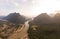 Aerial unique view from drone: Nam Ou river valley at Muang Ngoi Laos, sunset colorful sky, dramatic mountain landscape, travel