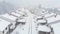 AERIAL: Unrecognizable adult person shoveling their driveway during a snowstorm.